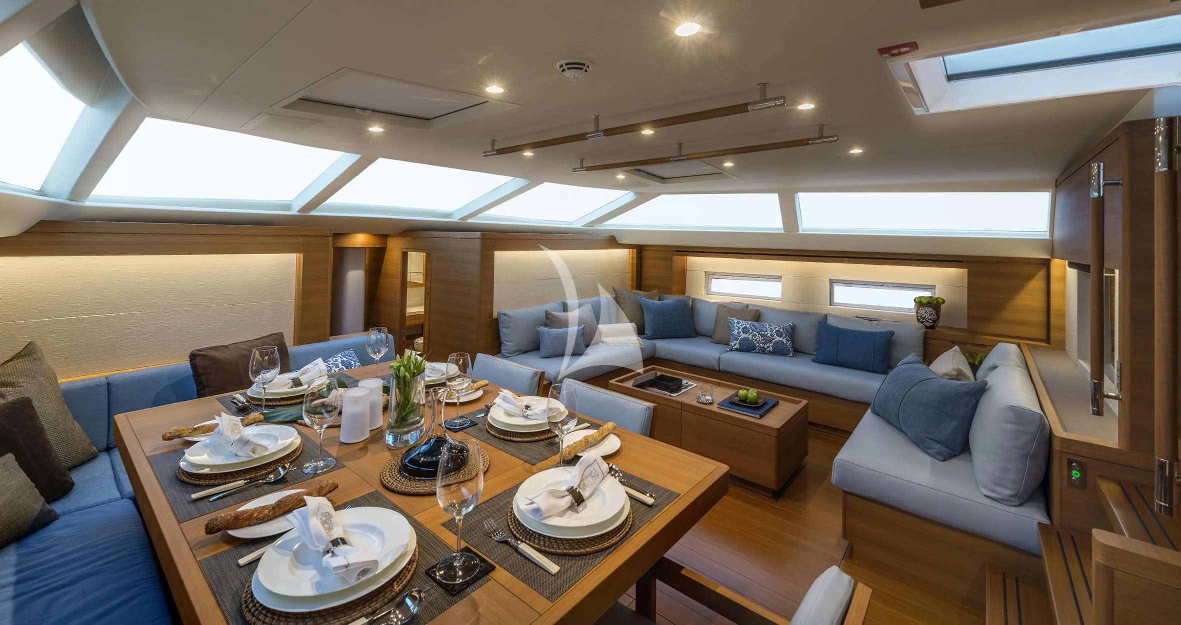 a living room with a table and couches aboard FARFALLA Yacht for Sale