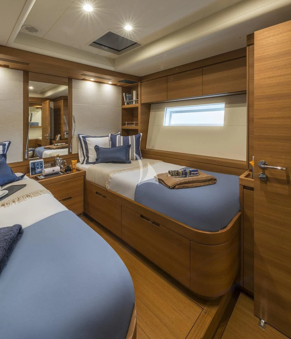 a bedroom with a bed and a mirror aboard FARFALLA Yacht for Sale