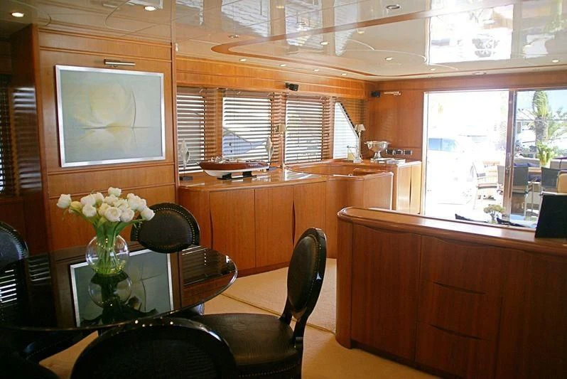 a room with a tv and flowers aboard AMANZI Yacht for Sale