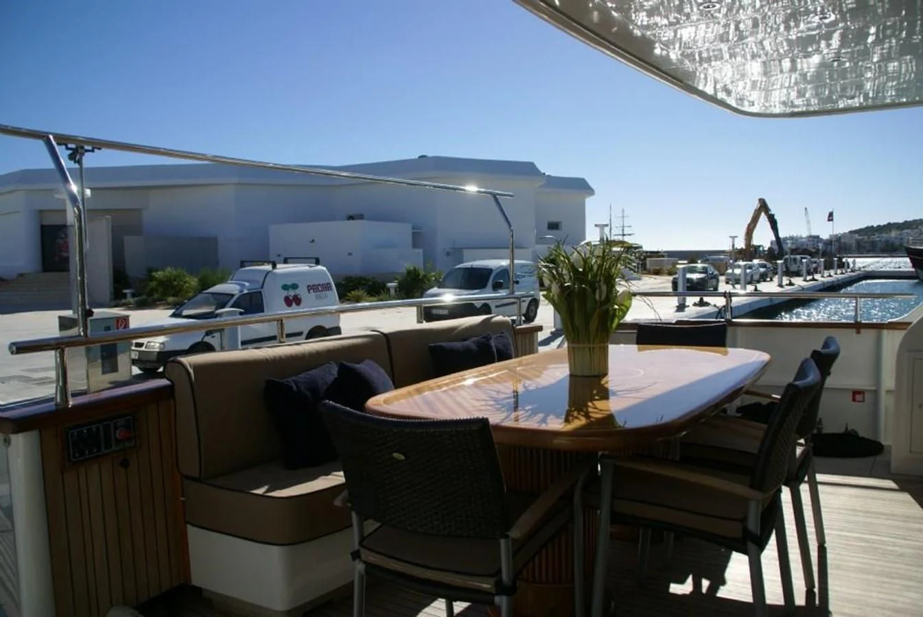 a table and chairs on a deck aboard AMANZI Yacht for Sale