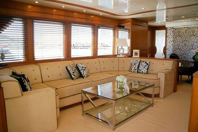 a living room with a couch and coffee table aboard AMANZI Yacht for Sale