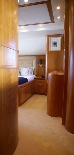 a bedroom with a wood closet aboard AMANZI Yacht for Sale
