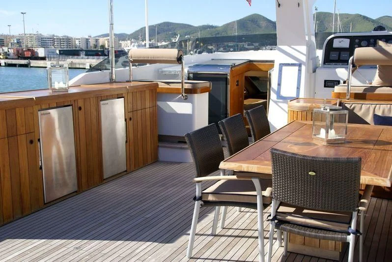 a table and chairs on a deck aboard AMANZI Yacht for Sale