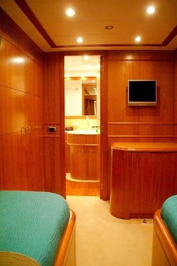 a bathroom with a bed and a television aboard AMANZI Yacht for Sale