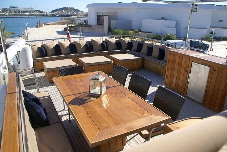 a room with a table and chairs aboard AMANZI Yacht for Sale