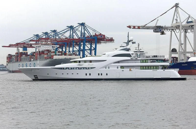 a large white boat in a harbor aboard KOSATKA Yacht for Sale