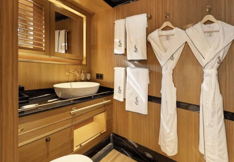 a bathroom with a robe on the wall aboard SALLYNA Yacht for Sale