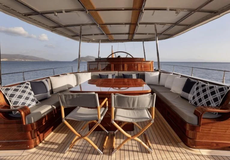 a deck with chairs and tables on it aboard SALLYNA Yacht for Sale