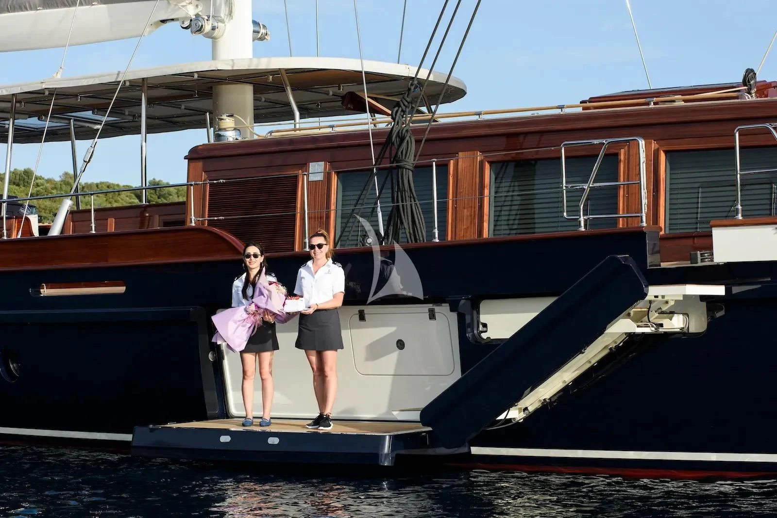 a man and woman holding a child on a boat aboard SALLYNA Yacht for Sale