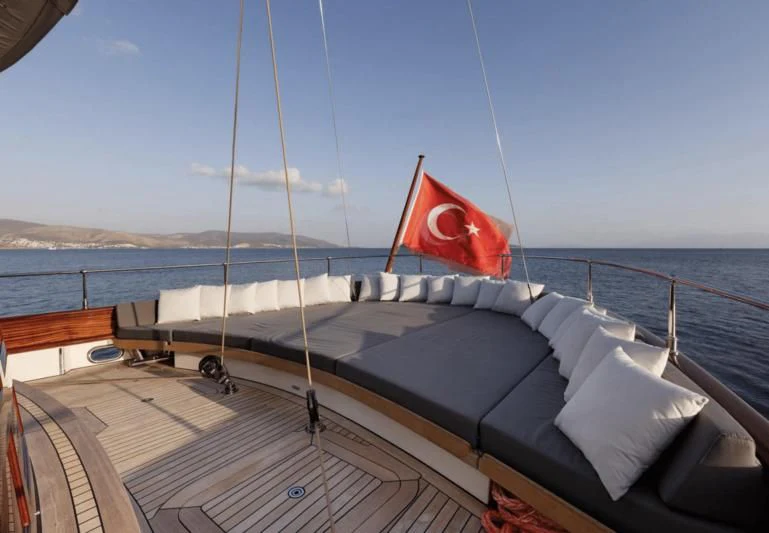 a boat with a flag on the front aboard SALLYNA Yacht for Sale