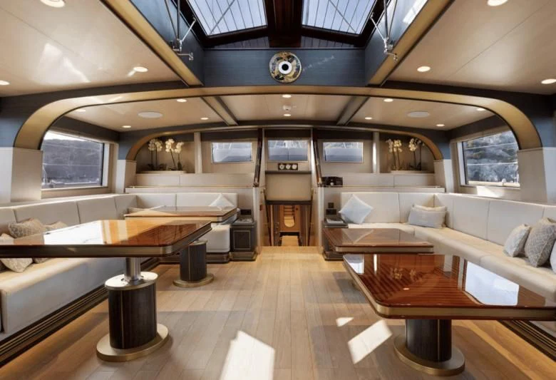 a room with benches and a table aboard SALLYNA Yacht for Sale