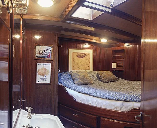 a bedroom with a bed and a sink aboard EILEEN II Yacht for Sale