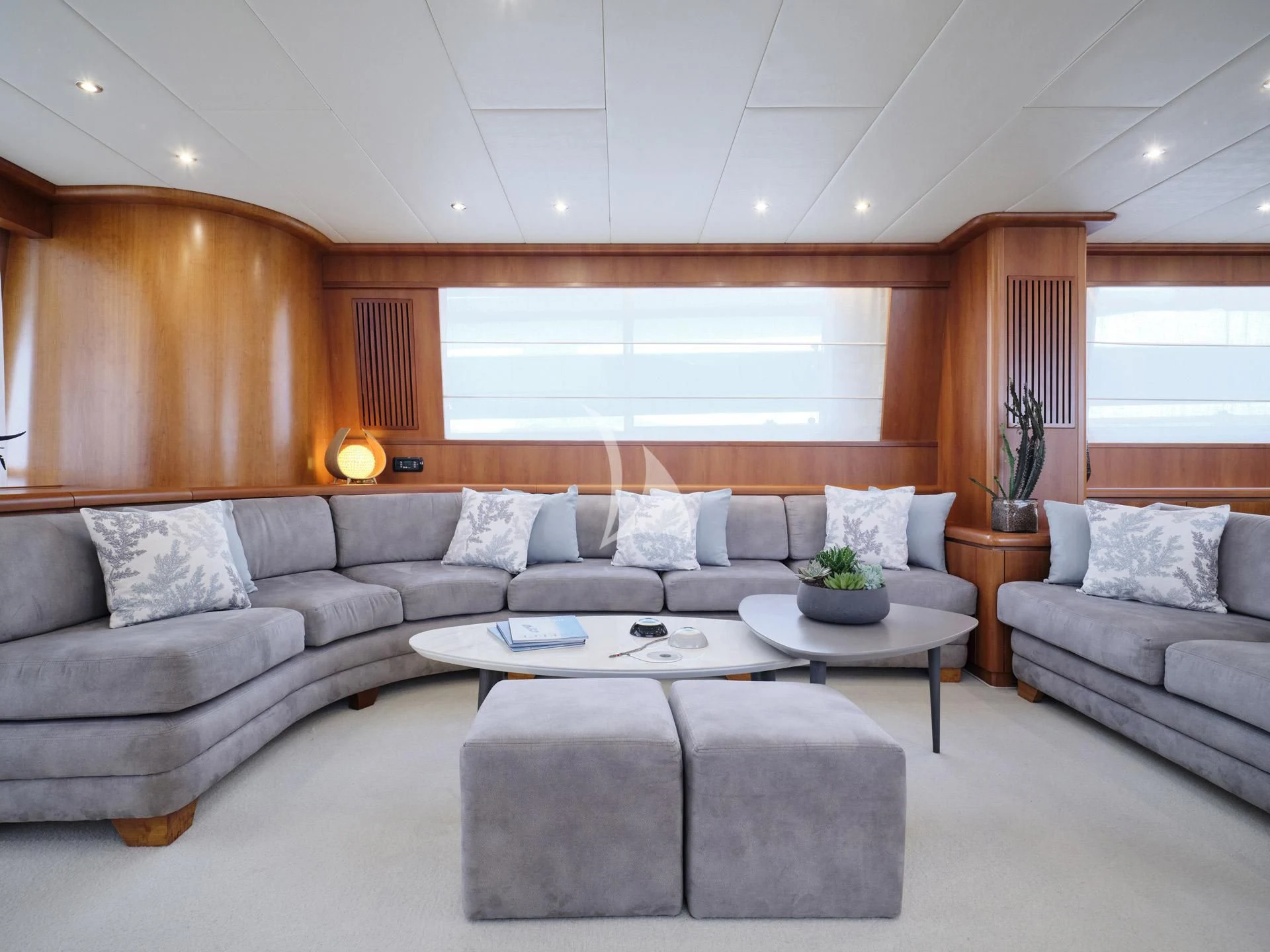 a living room with a couch and a coffee table aboard MANTRA Yacht for Sale