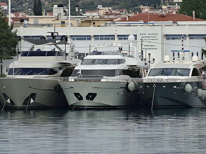 several white yachts in a harbor aboard MANTRA Yacht for Sale
