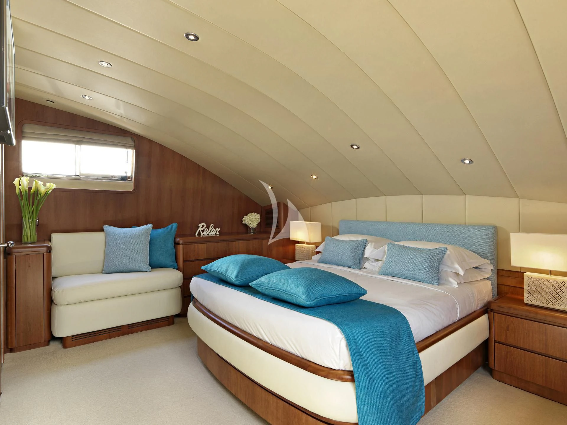 a room with a bed and a couch aboard MANTRA Yacht for Sale