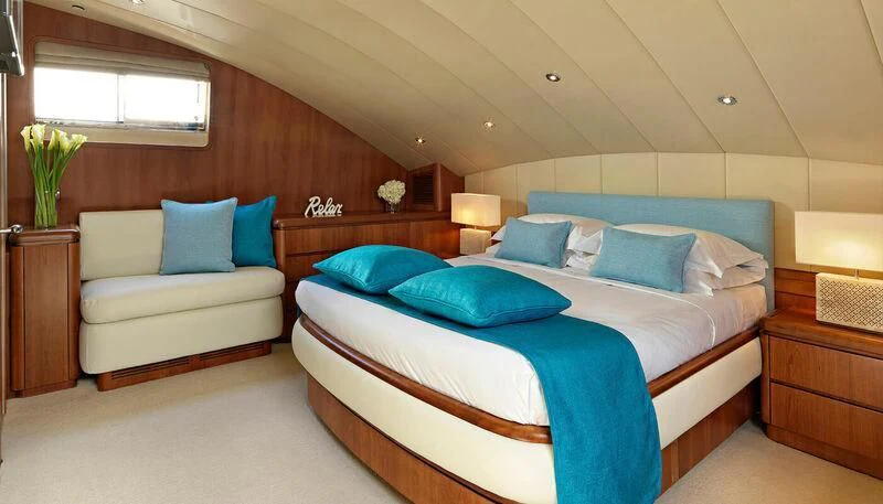 a bedroom with a bed and a desk aboard MANTRA Yacht for Sale