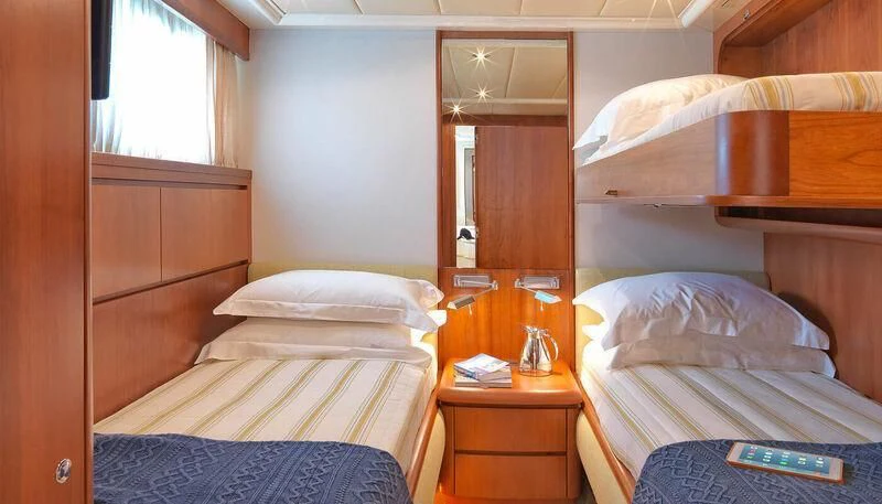 a room with two beds aboard MANTRA Yacht for Sale