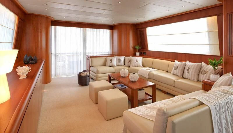 a living room with a couch and a coffee table aboard MANTRA Yacht for Sale