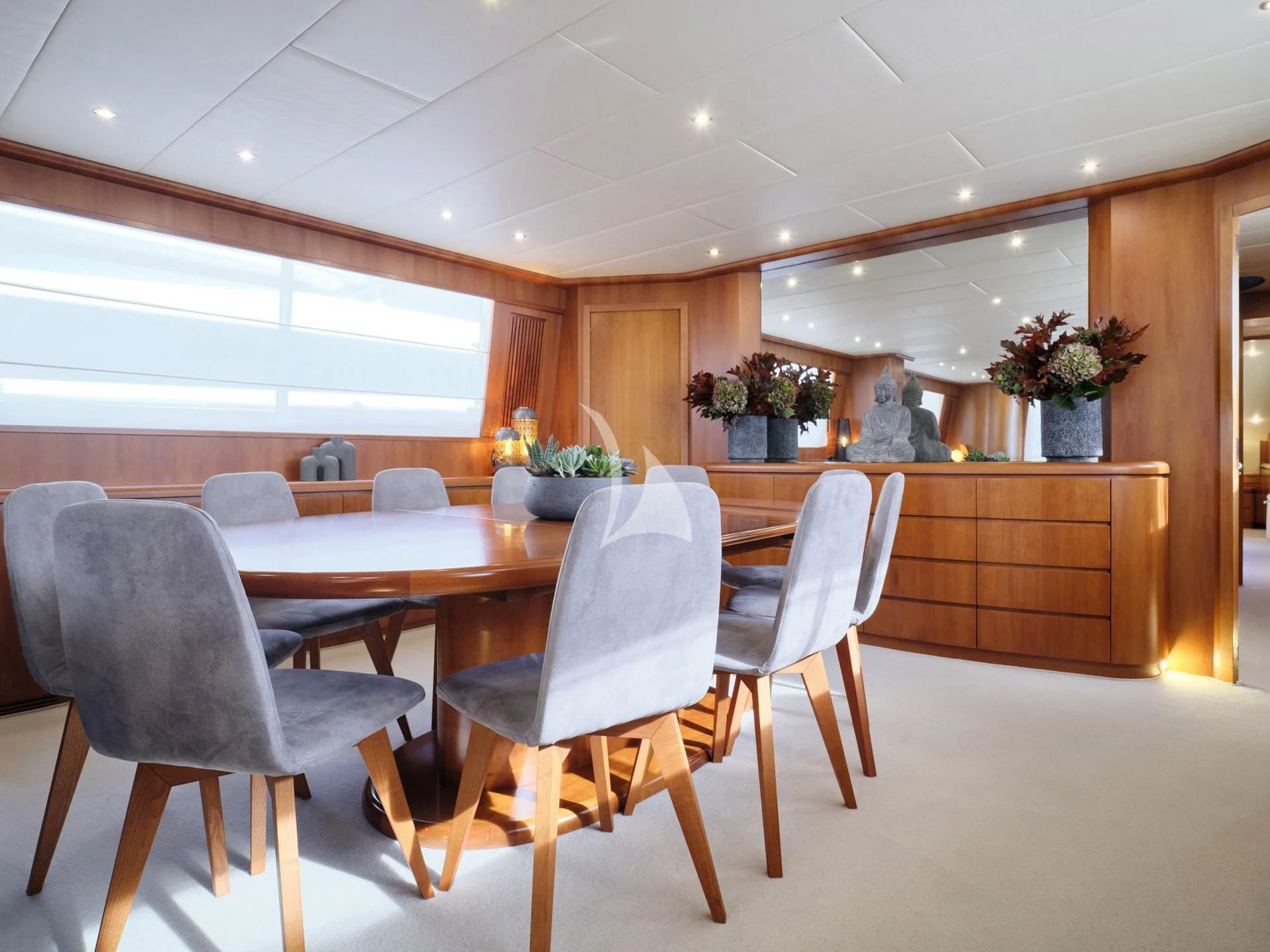 a large kitchen with a dining table aboard MANTRA Yacht for Sale