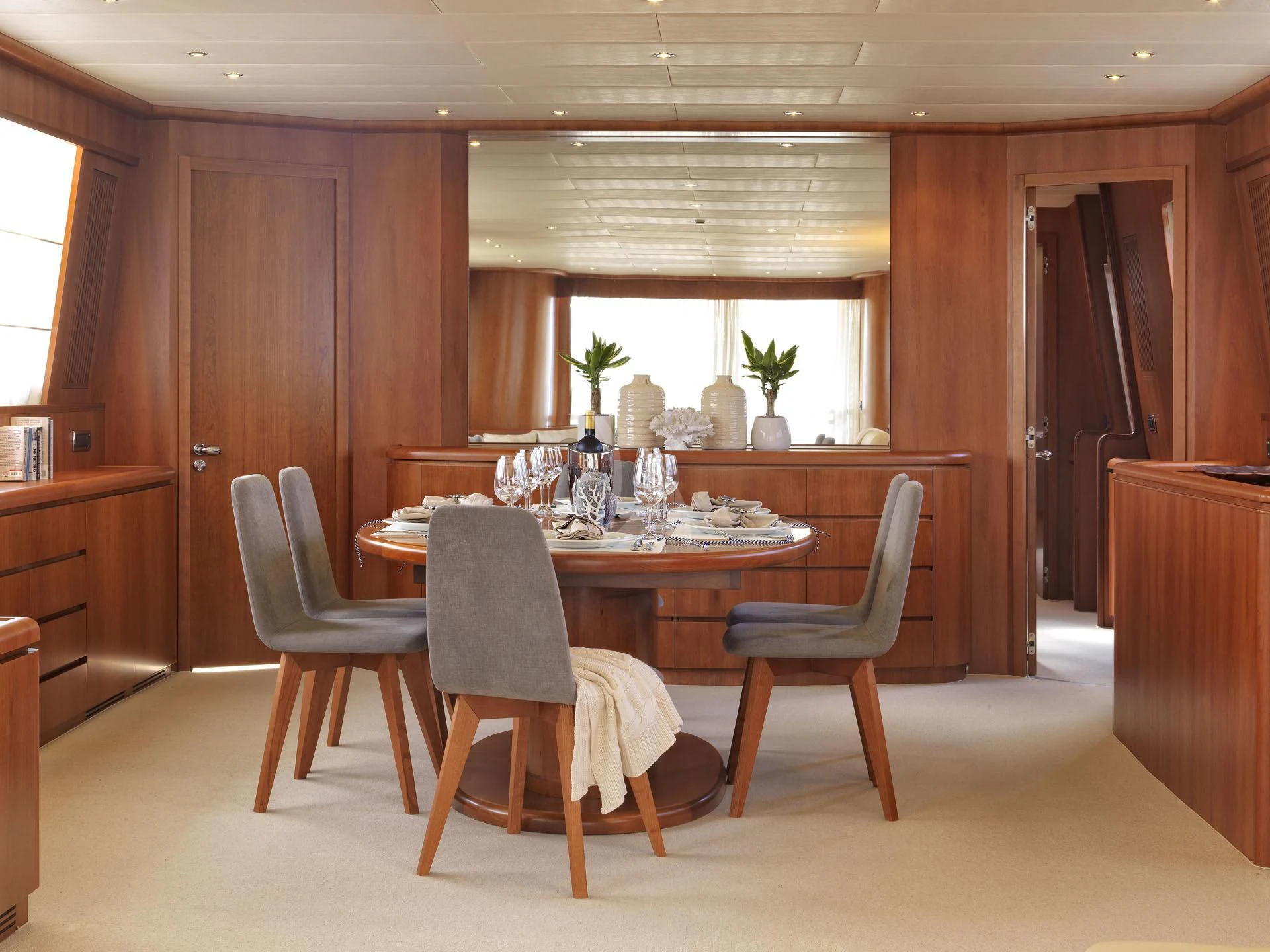 a dining room table and chairs aboard MANTRA Yacht for Sale