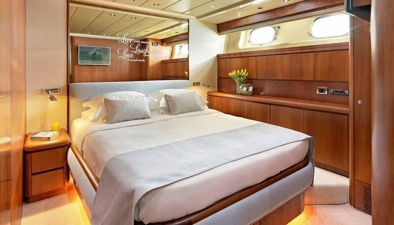 a bed with white sheets aboard MANTRA Yacht for Sale