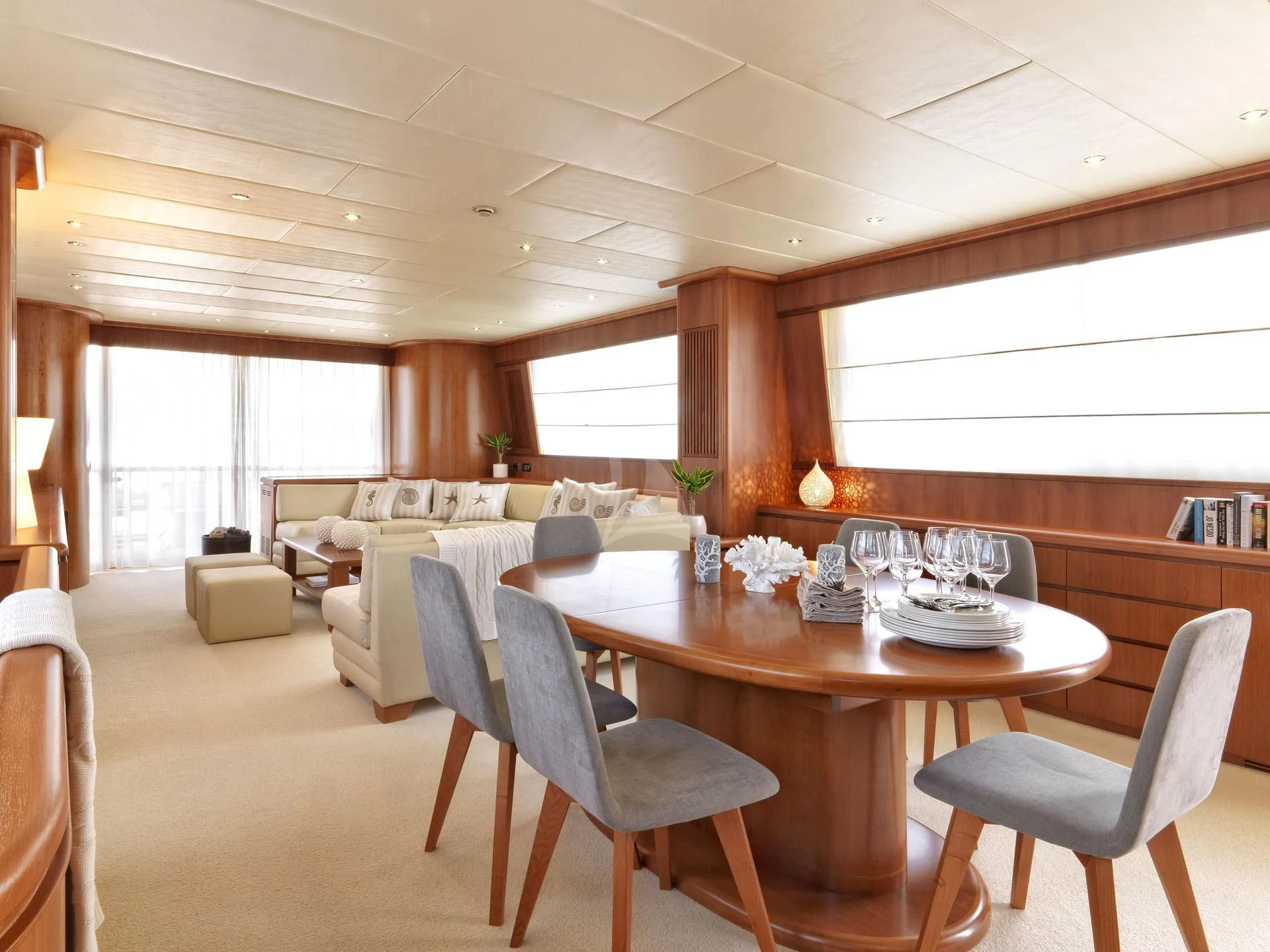 a large living room with a large bed and a table aboard MANTRA Yacht for Sale