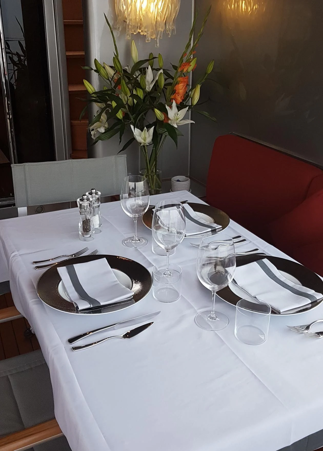 a table with place settings aboard TEMPEST WS Yacht for Charter