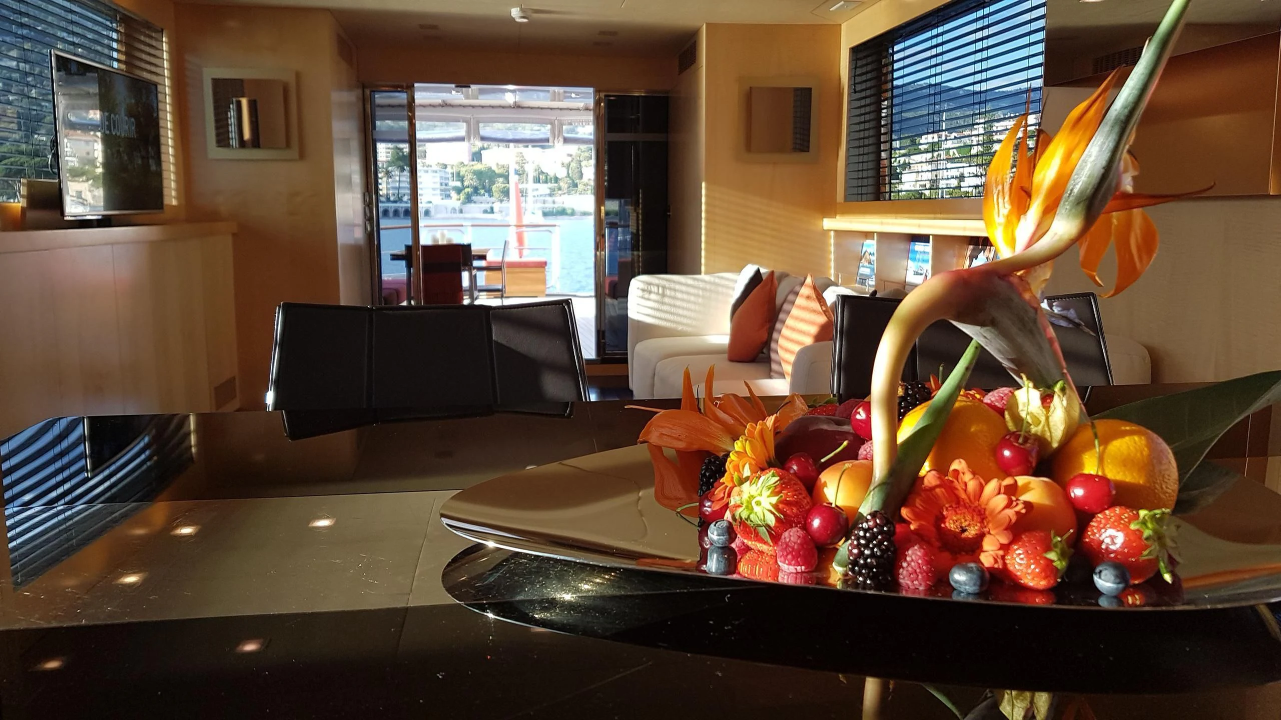 a large room with a table and chairs and a plant in it aboard TEMPEST WS Yacht for Charter