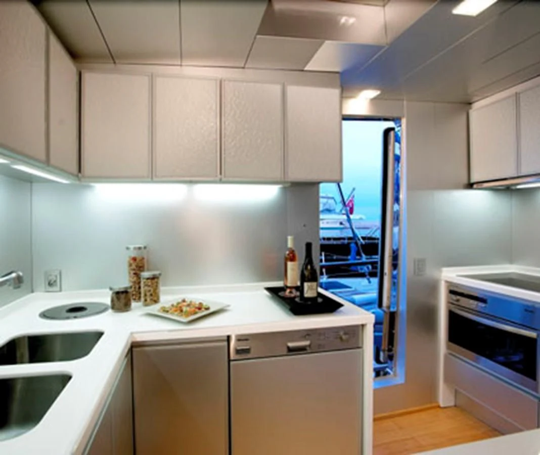 a kitchen with white cabinets aboard TEMPEST WS Yacht for Charter