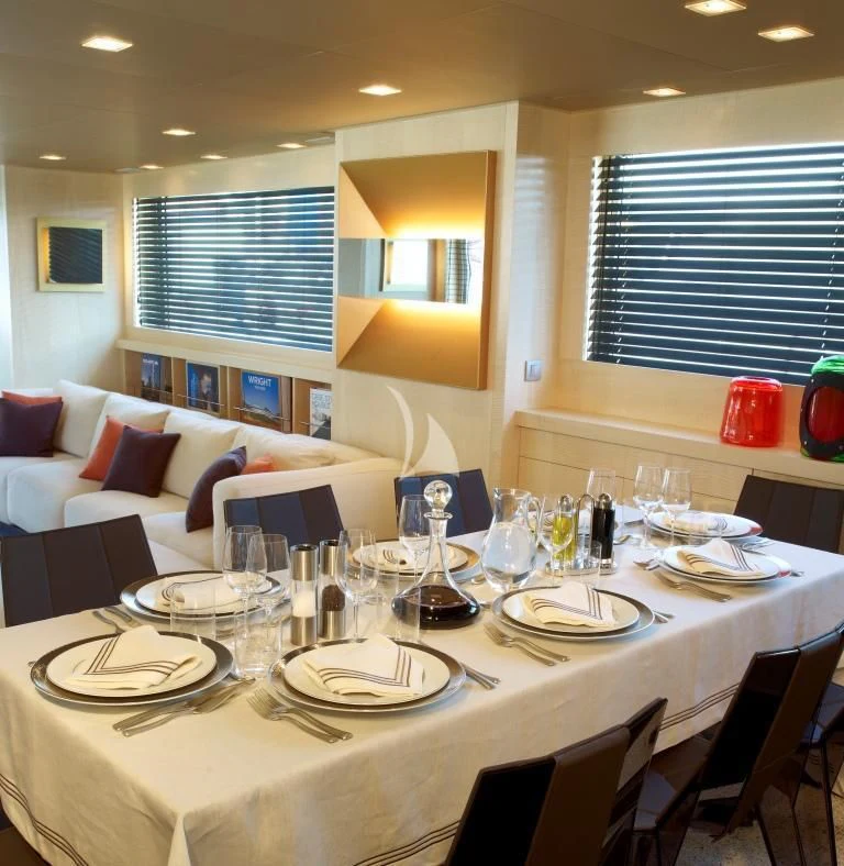 a table with plates and glasses aboard TEMPEST WS Yacht for Charter