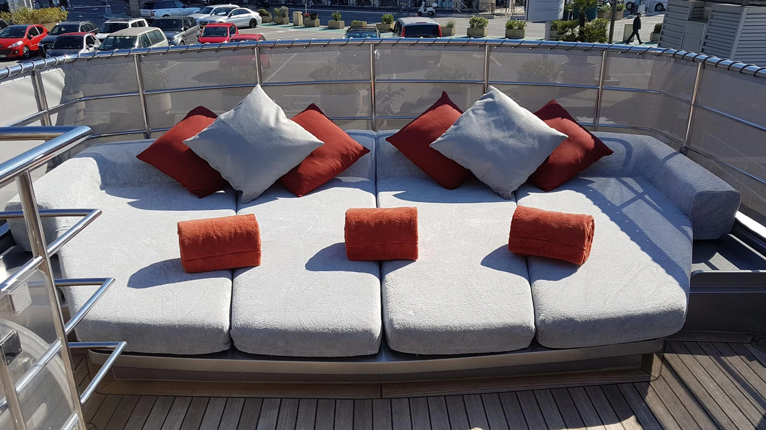 a white couch with red pillows aboard TEMPEST WS Yacht for Charter