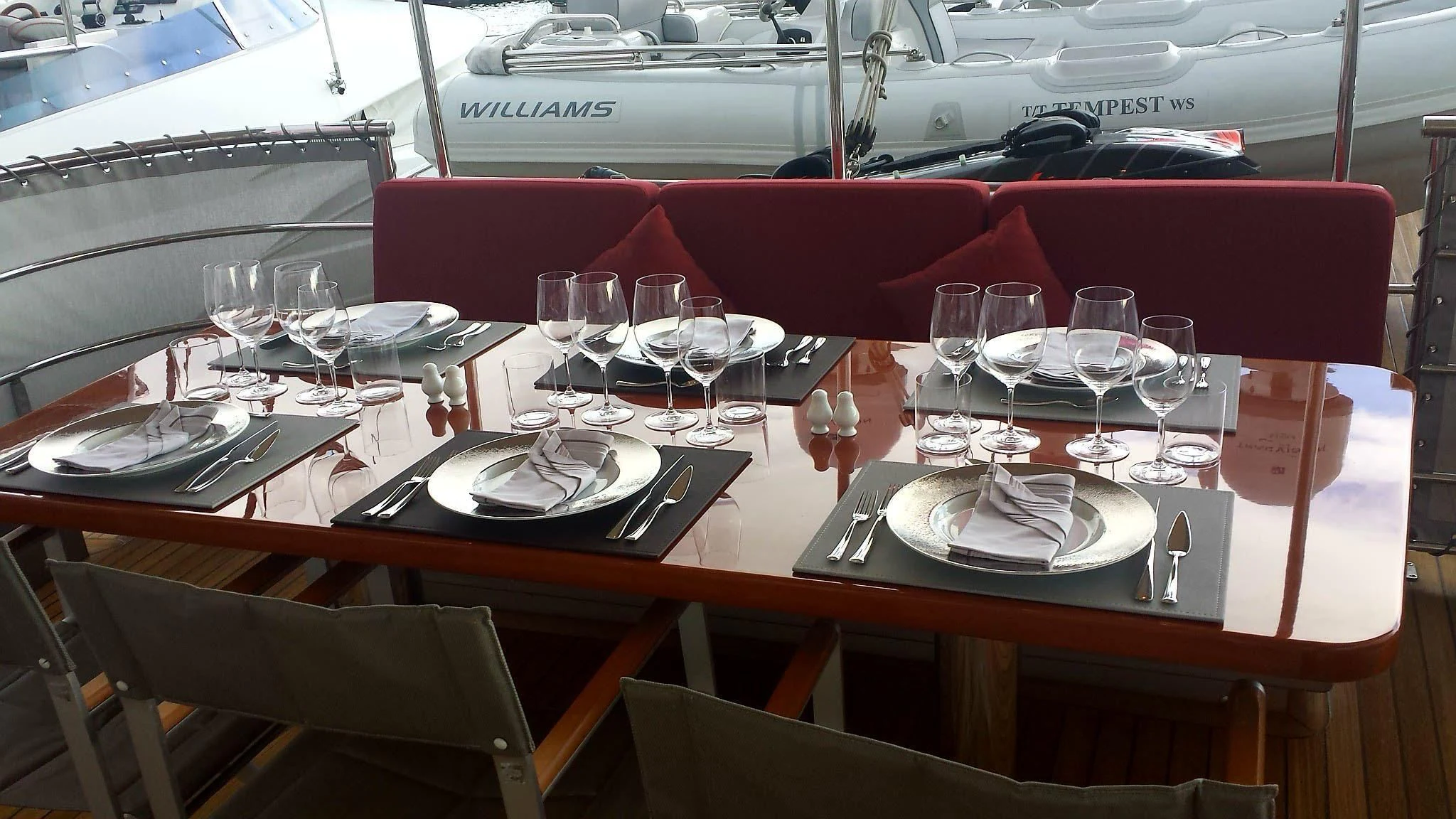 a table with plates and glasses aboard TEMPEST WS Yacht for Charter