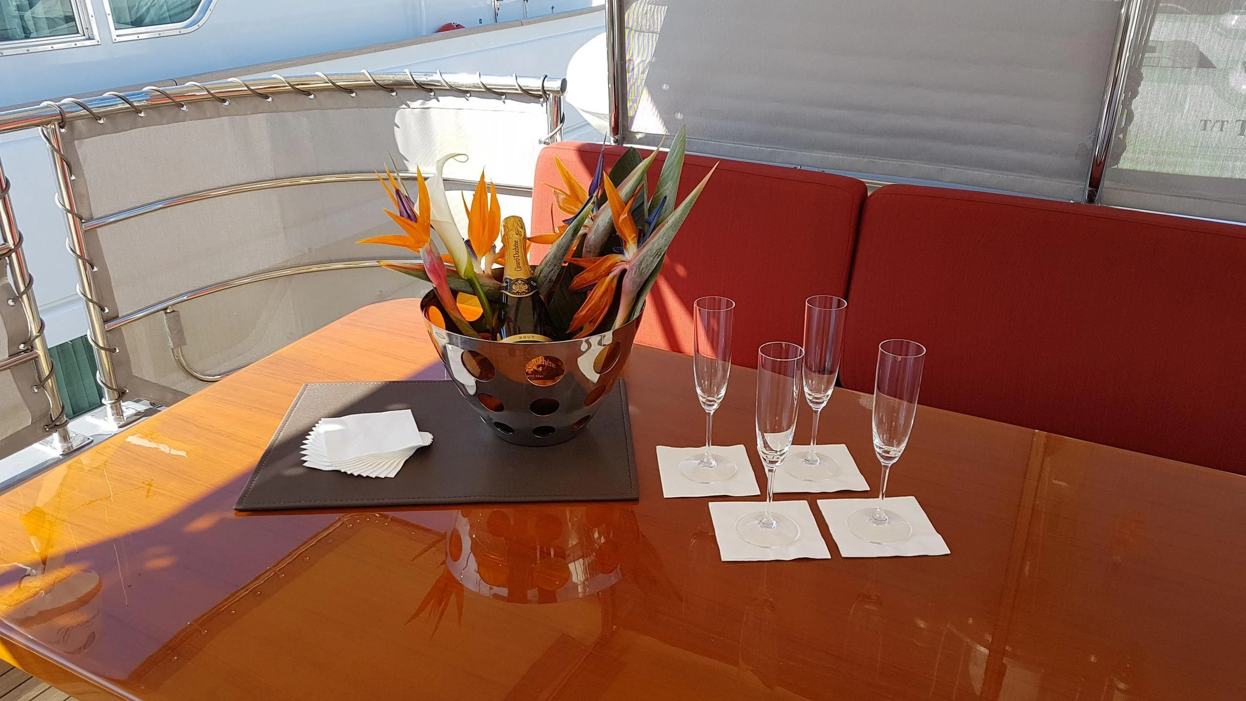 a table with wine glasses and a potted plant aboard TEMPEST WS Yacht for Charter