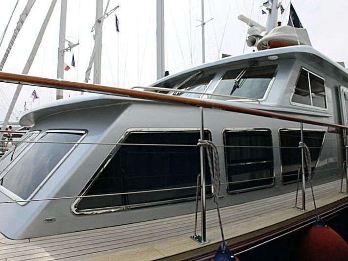 a white boat with a red and black stripe aboard TEMPEST WS Yacht for Charter