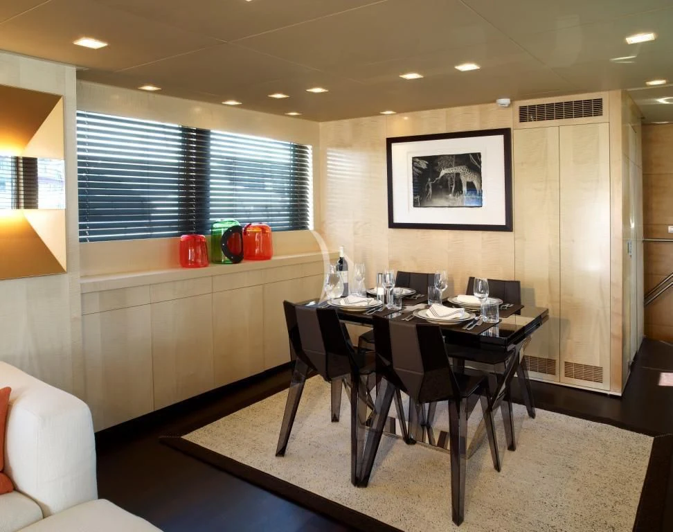 a dining room with a table and chairs aboard TEMPEST WS Yacht for Charter