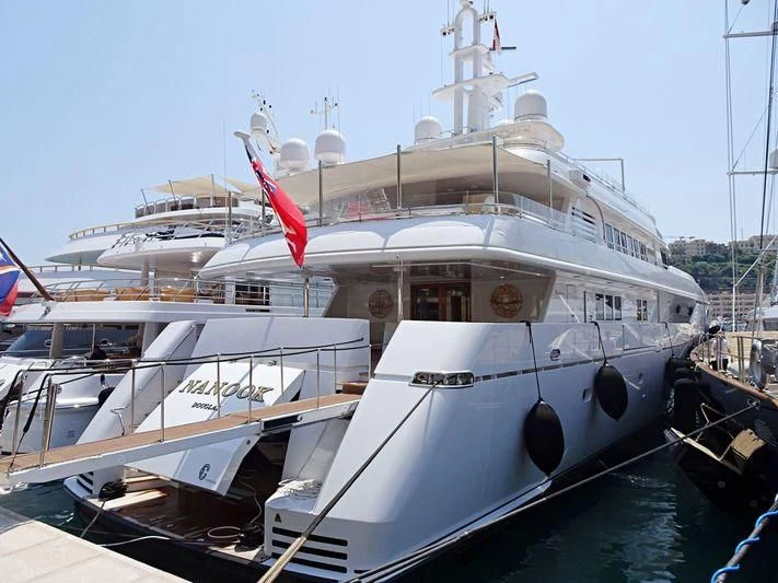 a large white boat with a red flag on it aboard TEMPO Yacht for Sale