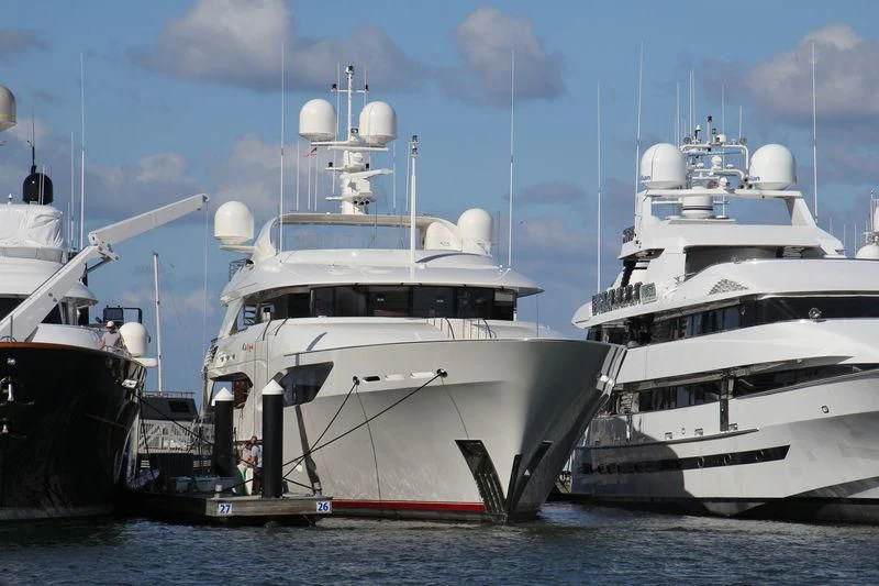 several large white boats in the water aboard AVALON Yacht for Sale