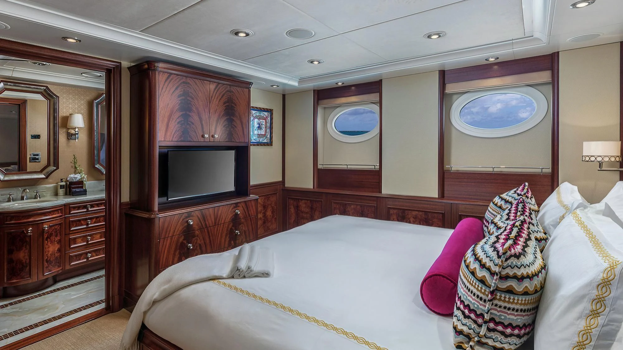 a bedroom with a bed and a television aboard AVALON Yacht for Sale