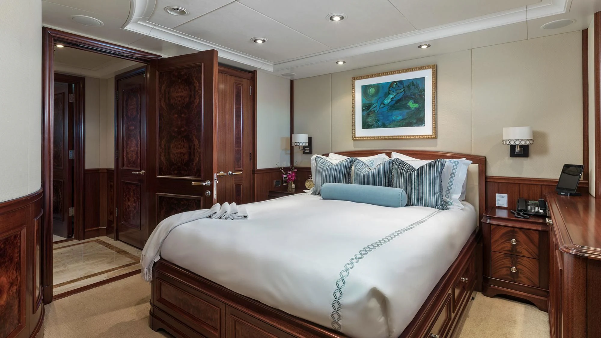 a bedroom with a bed and a dresser aboard AVALON Yacht for Sale