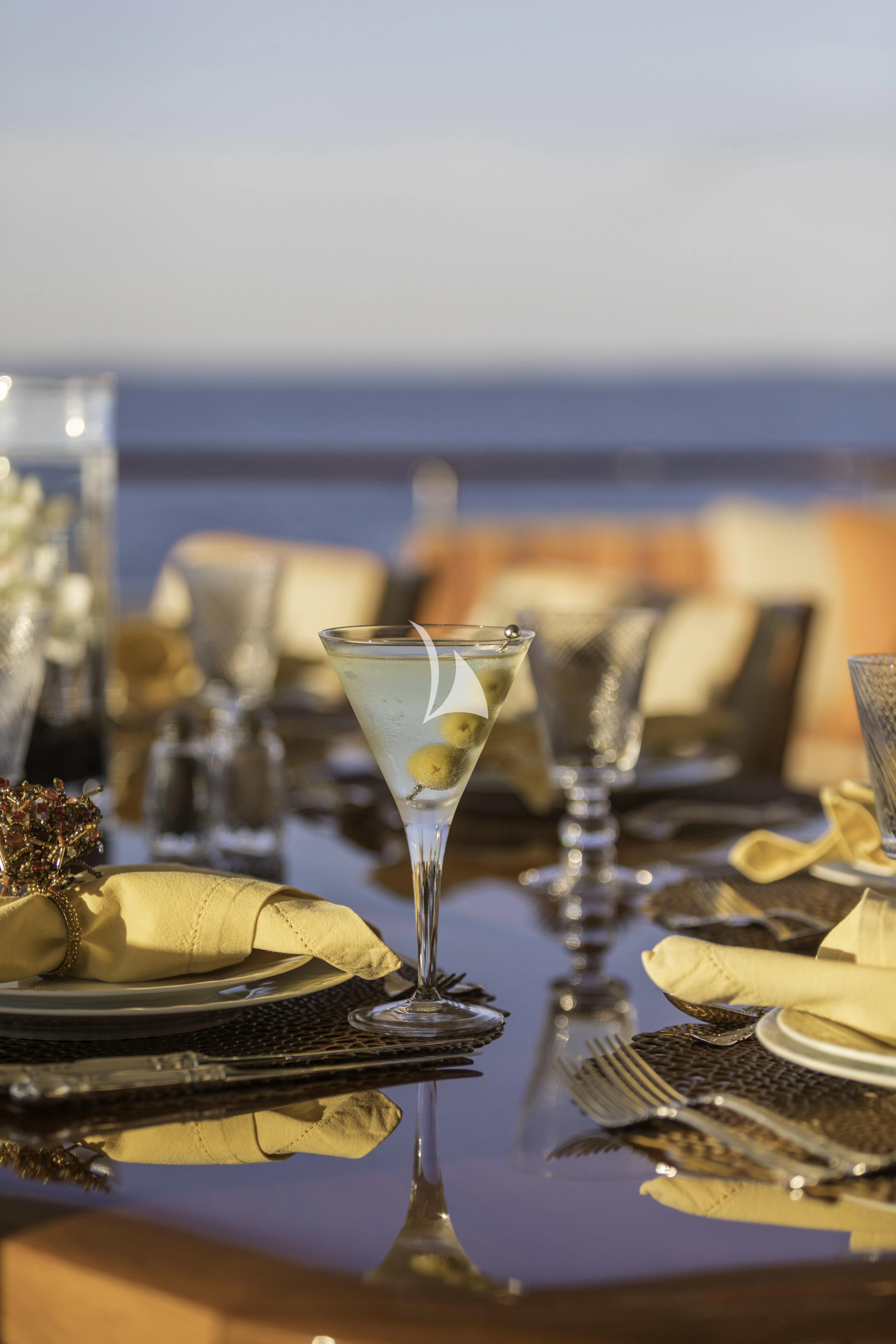 a table with plates and glasses on it aboard AVALON Yacht for Sale