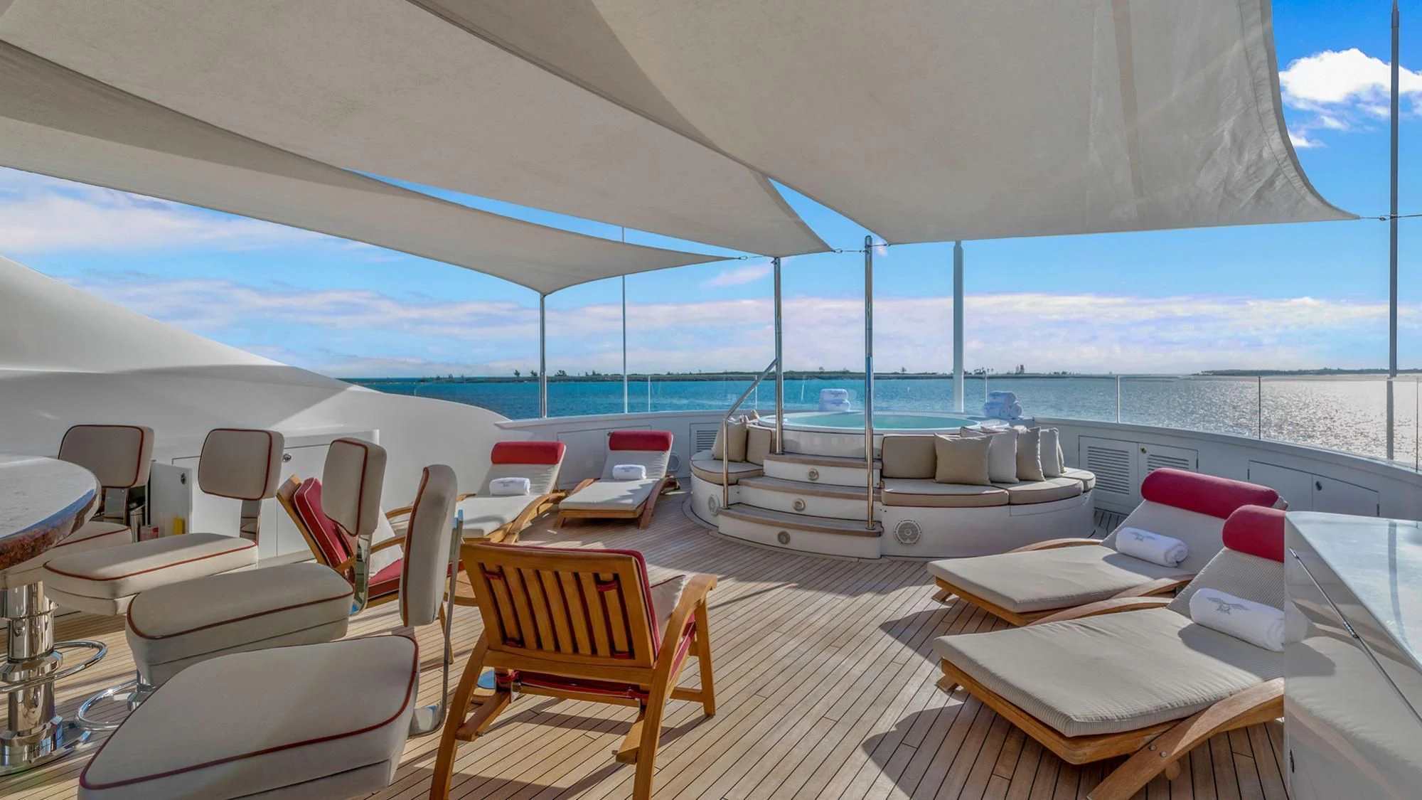 a room with a bed and chairs aboard AVALON Yacht for Sale