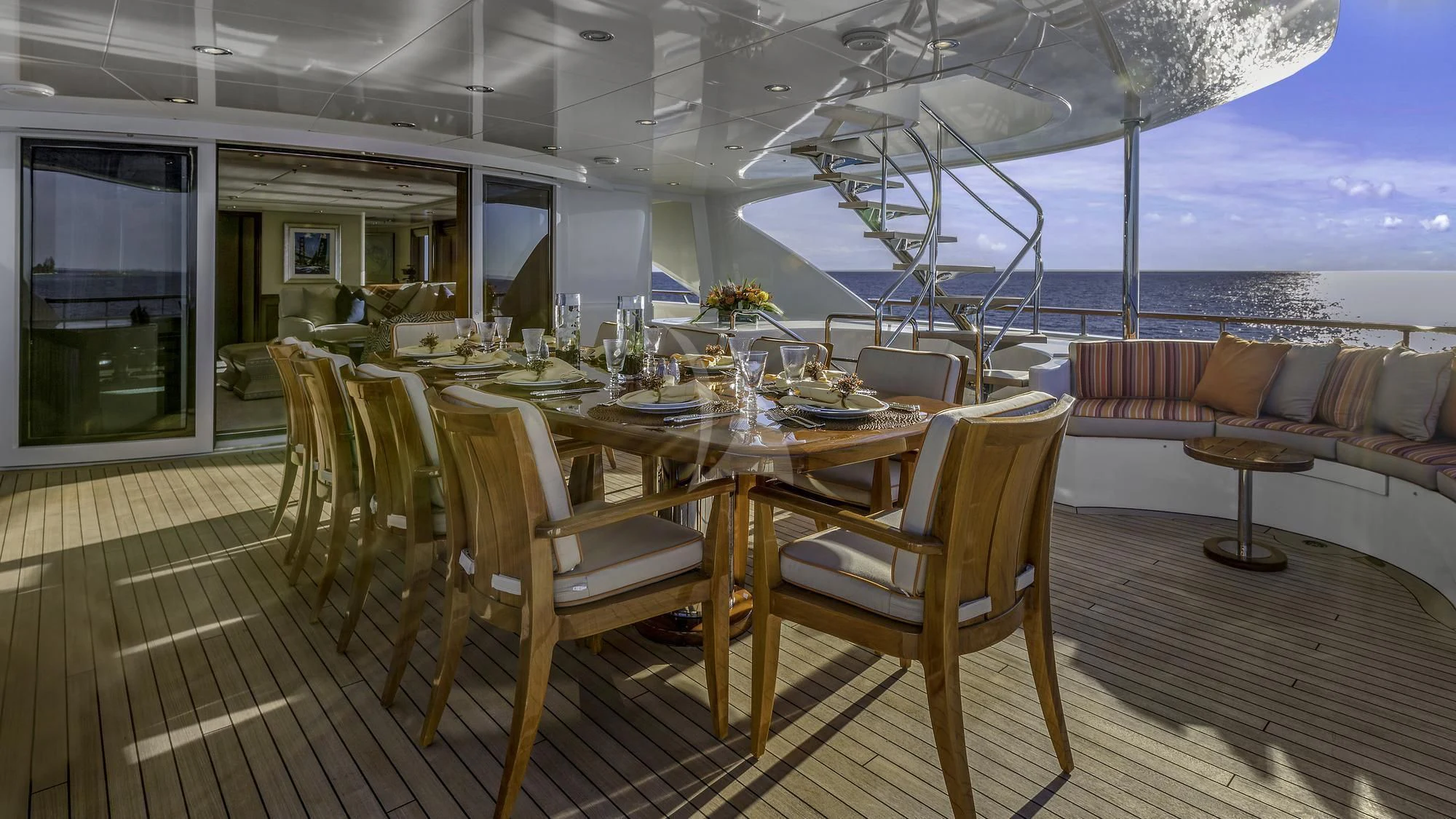 a table and chairs on a deck aboard AVALON Yacht for Sale