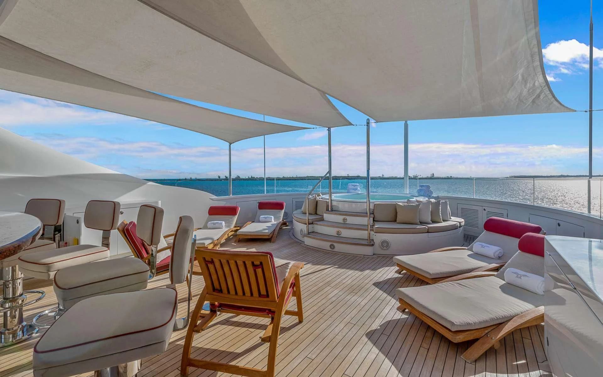 a room with a bed and chairs aboard AVALON Yacht for Sale