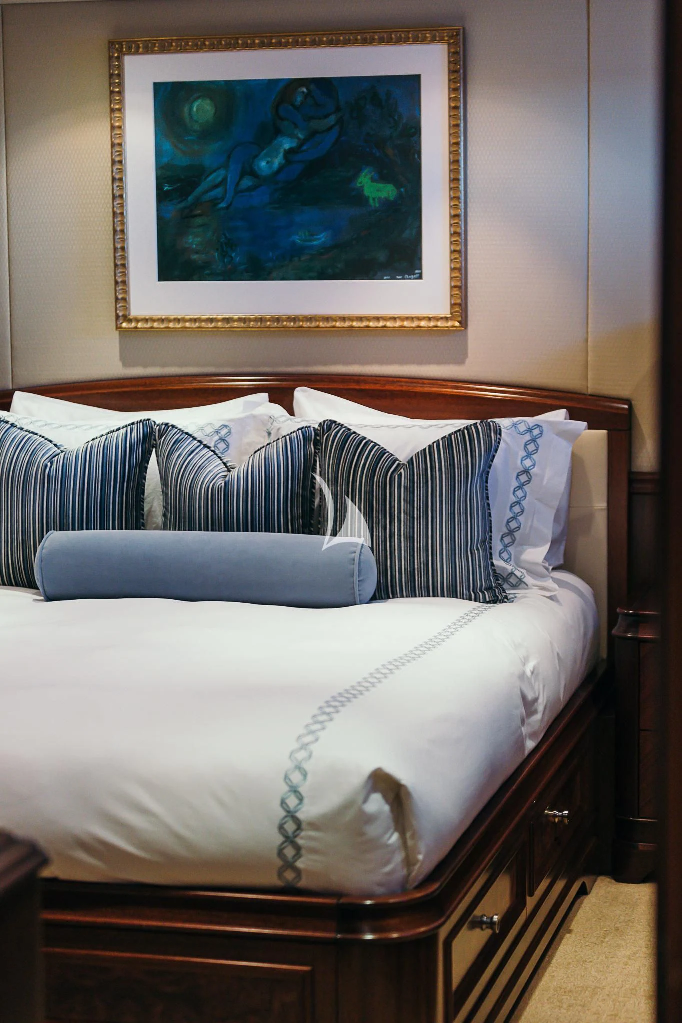 a bed with a painting on the wall aboard AVALON Yacht for Sale