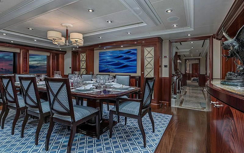 a dining room with a table and chairs aboard AVALON Yacht for Sale