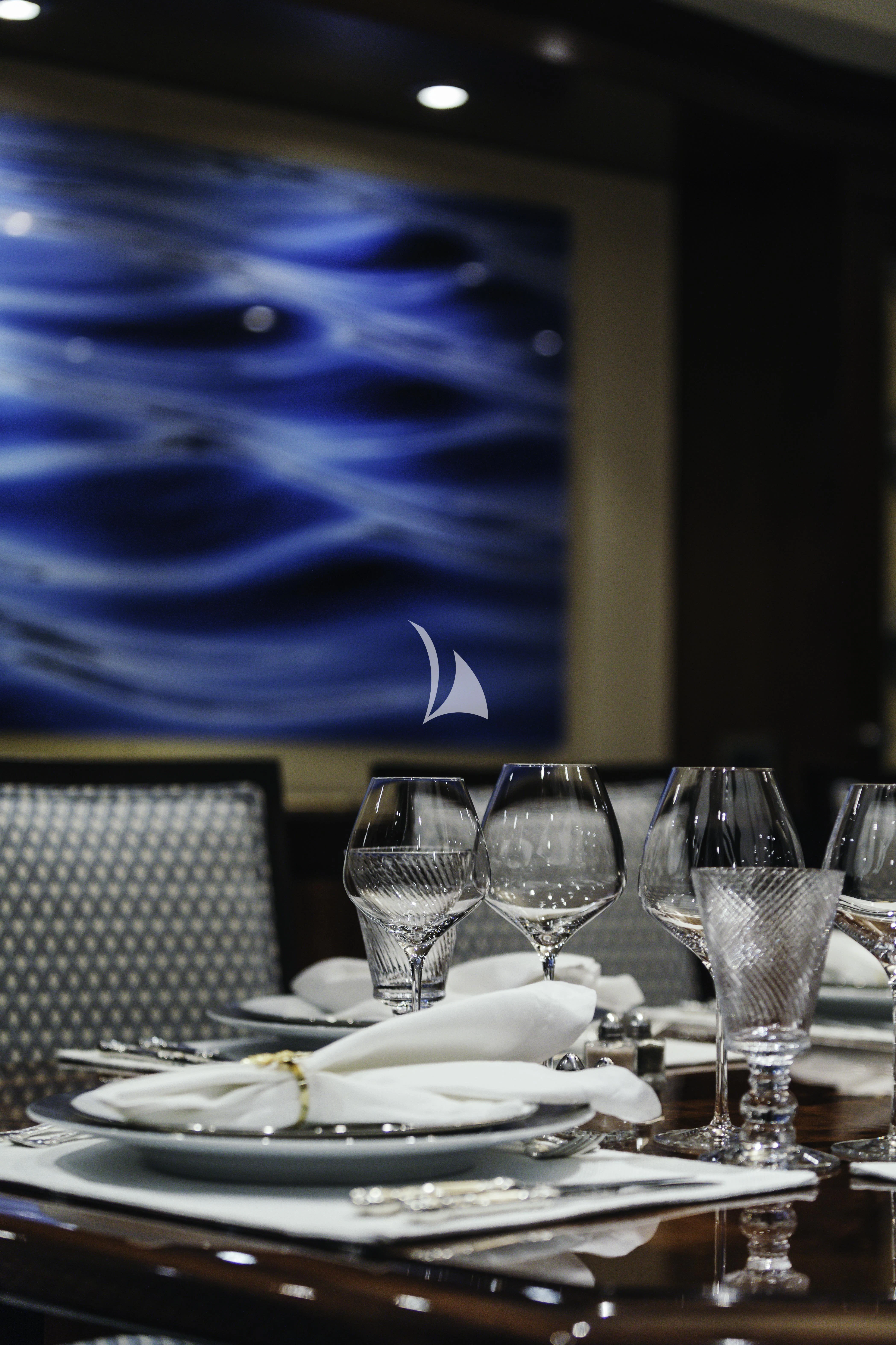 a table with plates and glasses on it aboard AVALON Yacht for Sale