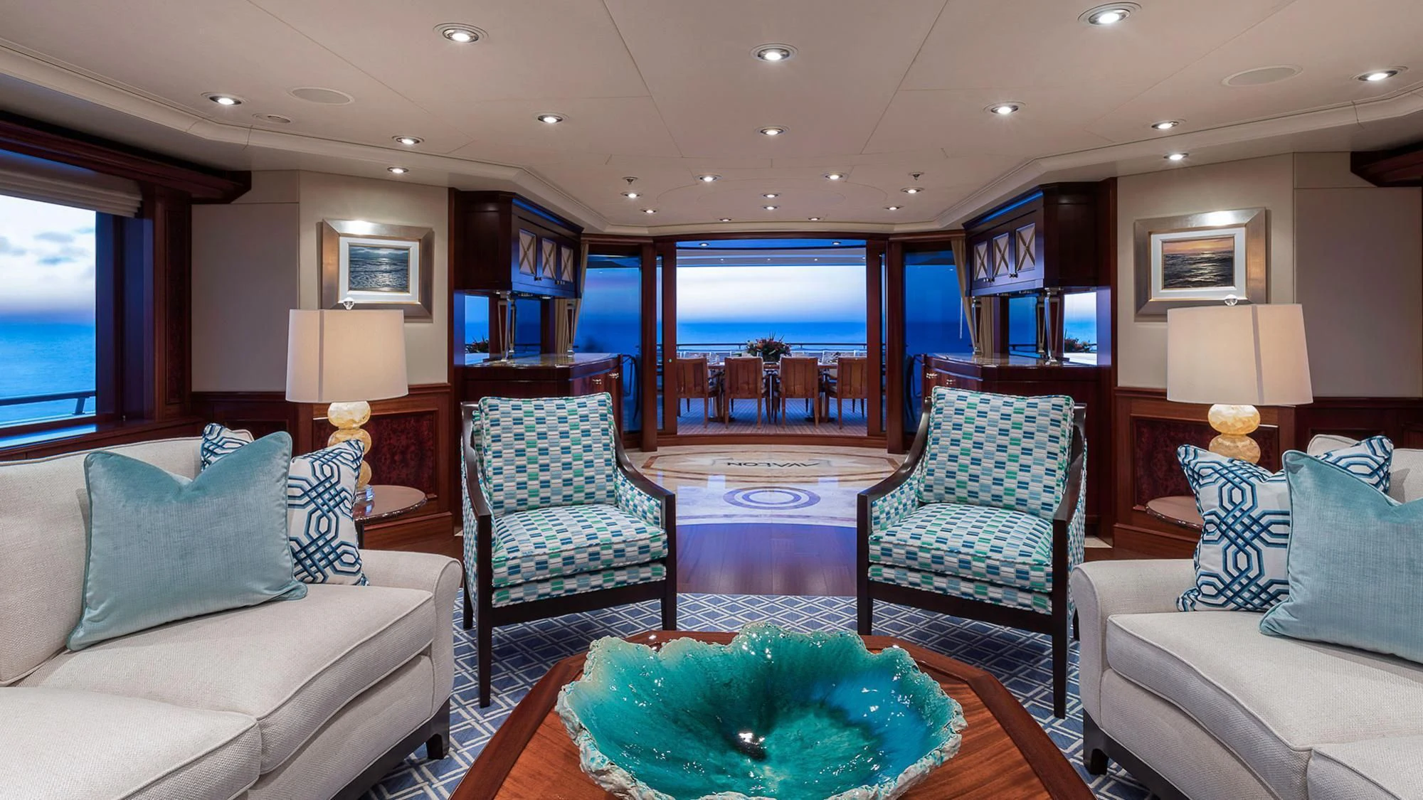 a living room with a round table aboard AVALON Yacht for Sale