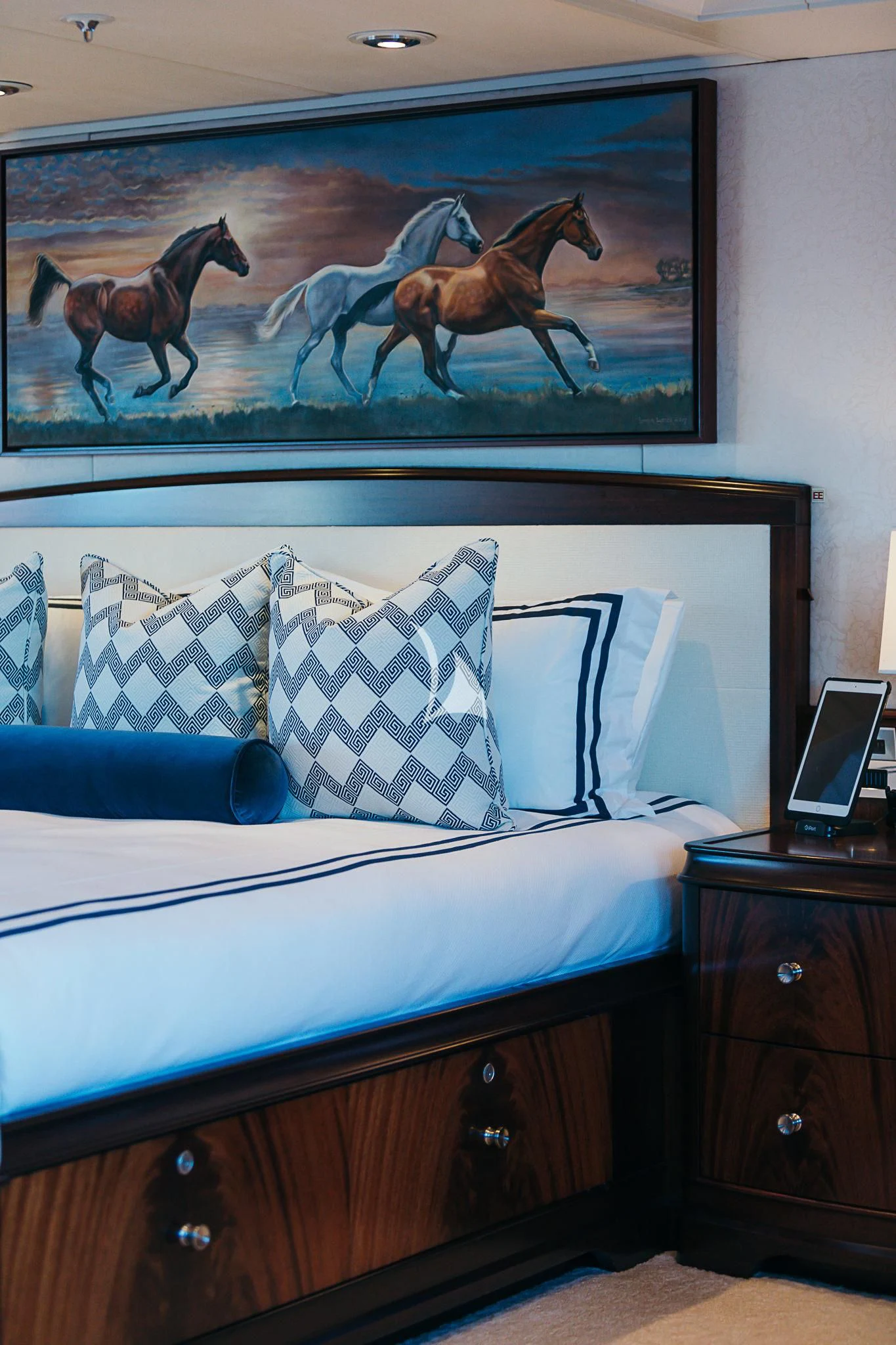 a bed with a painting on the wall aboard AVALON Yacht for Sale