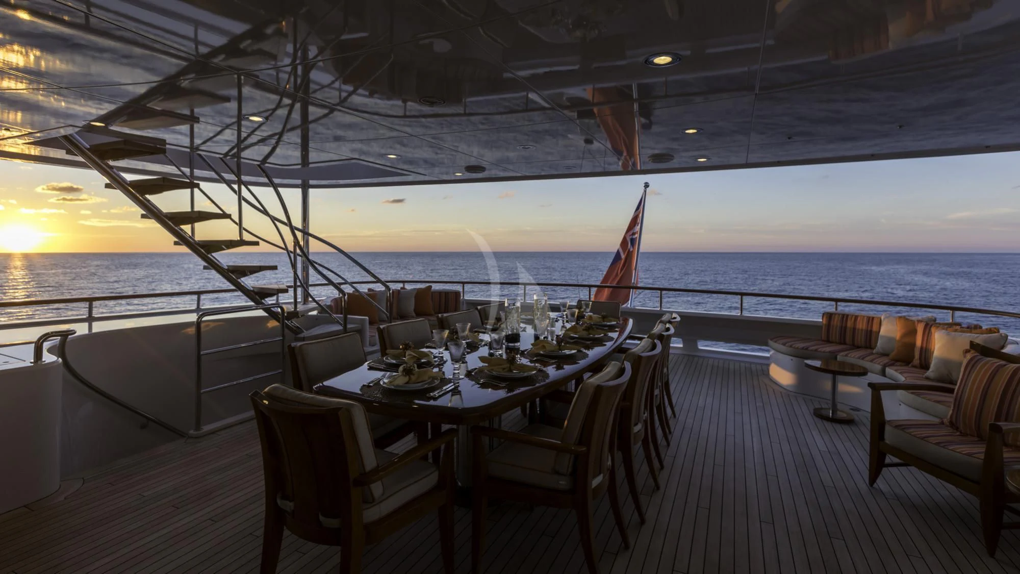 a deck with a table and chairs on it aboard AVALON Yacht for Sale