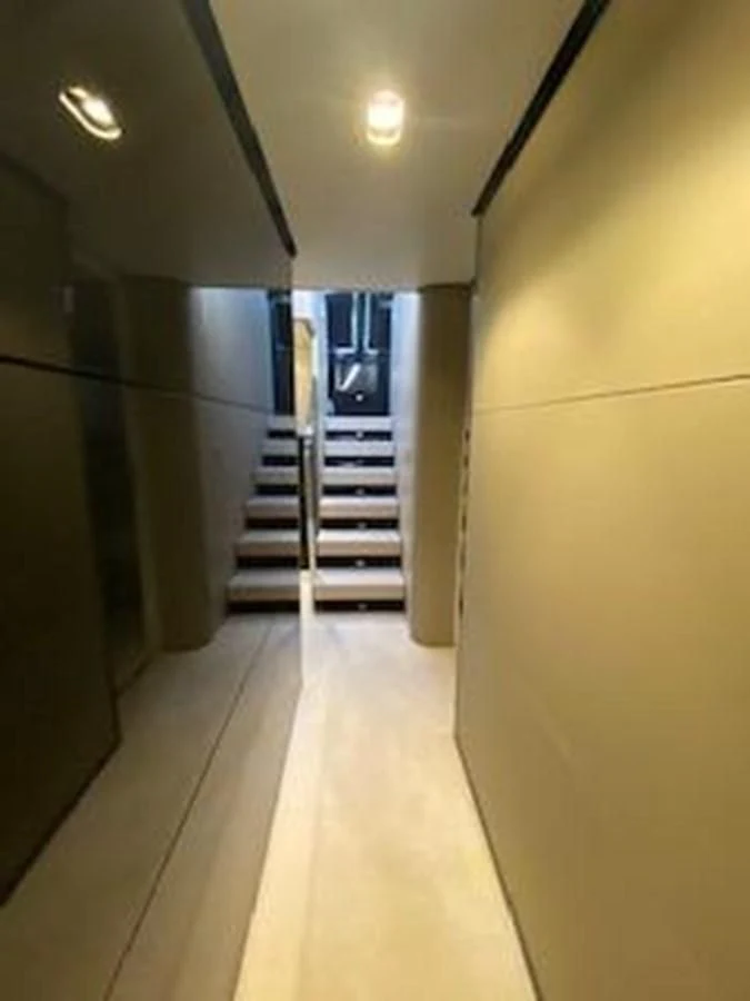 a hallway with a staircase and a glass door aboard FORTUNA Yacht for Sale